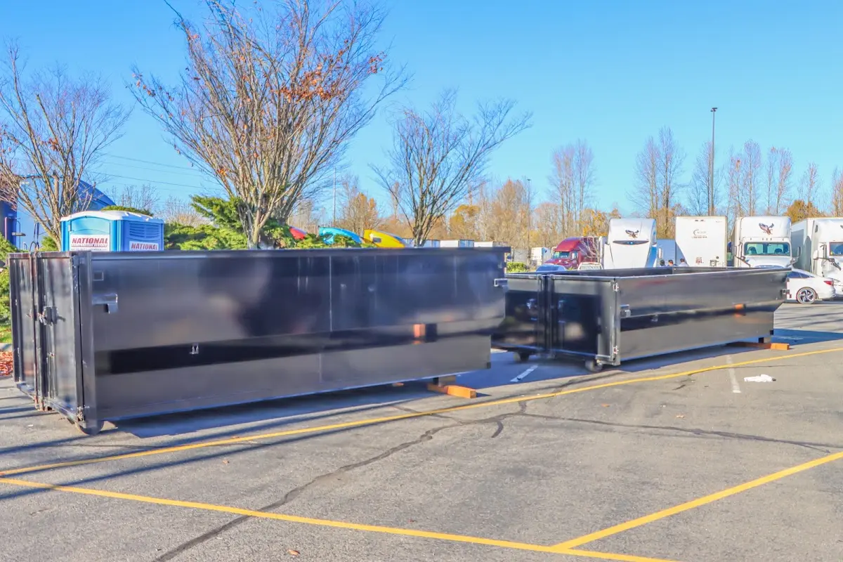 Professional dumpster rental service with roll-off container on residential driveway in Casa Grande